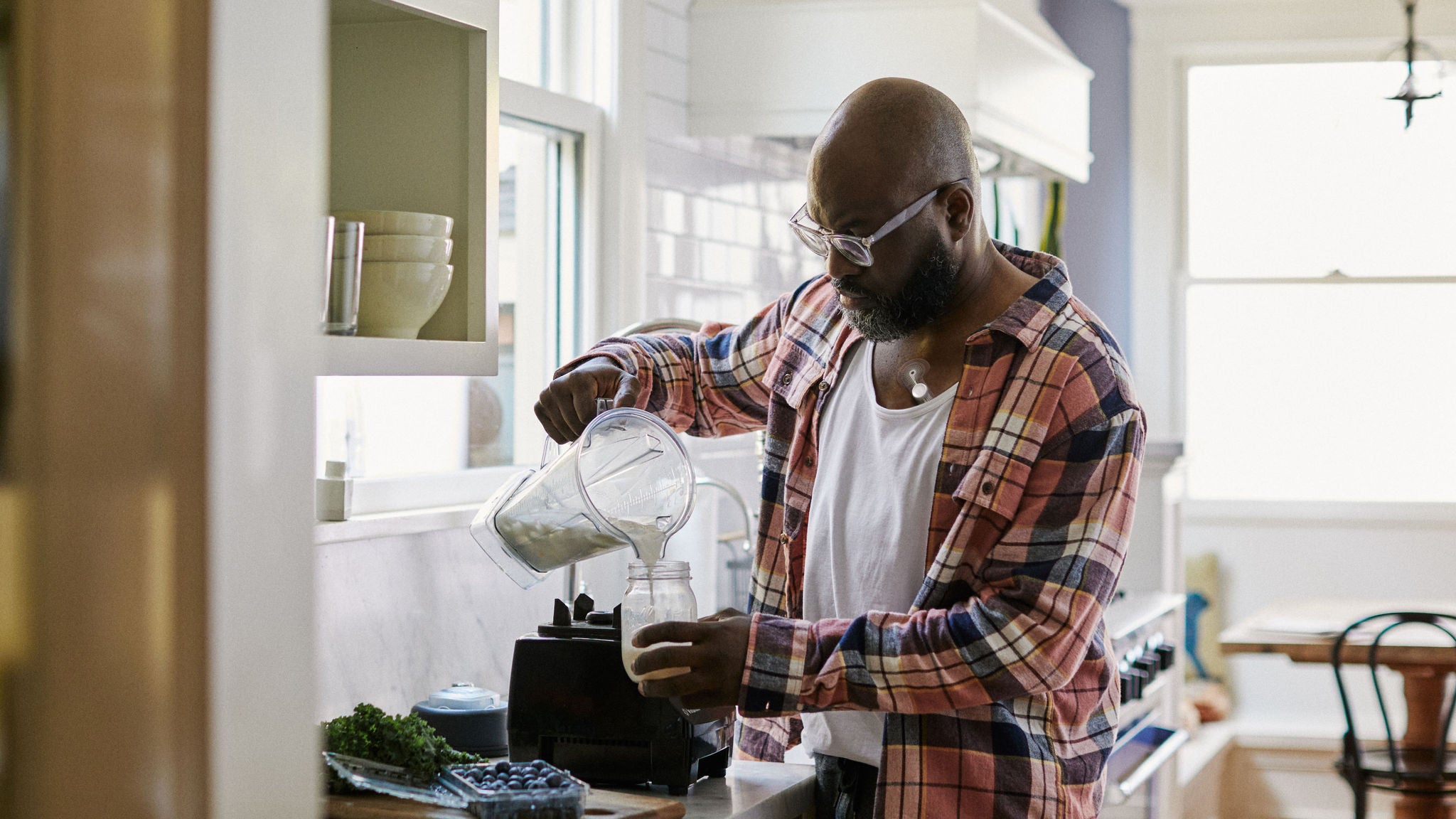 Patient wearing Zio monitor pouring a smoothie