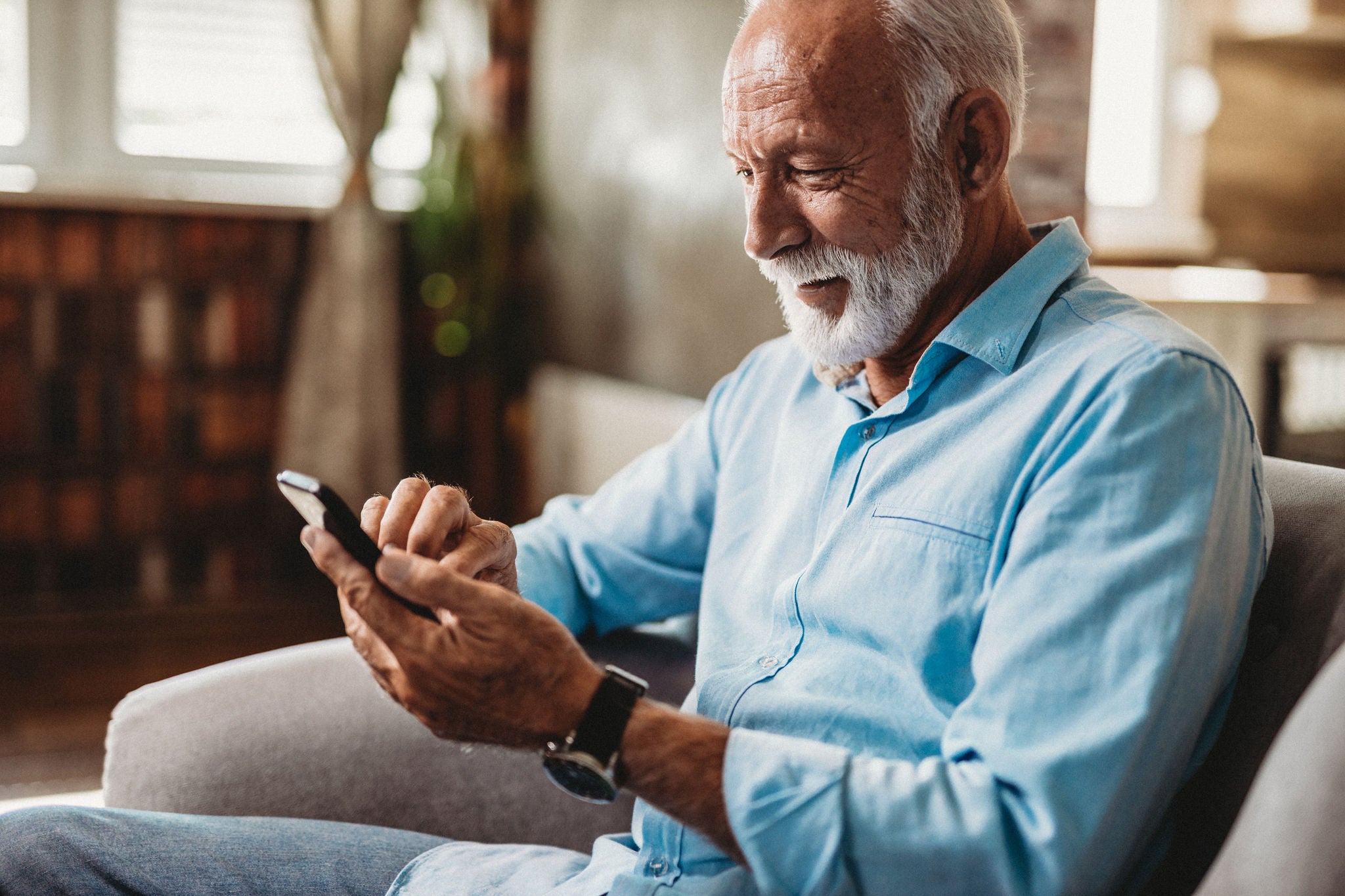 Senior man using his phone