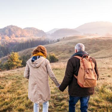 Two hikers holding hands 