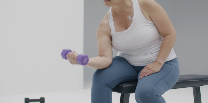 Woman with weights wearing Zio monitor 