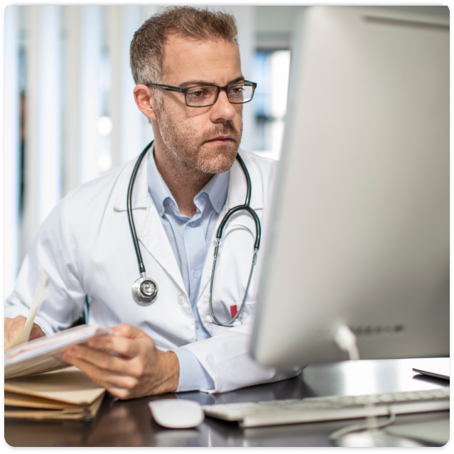 Physician looking at computer