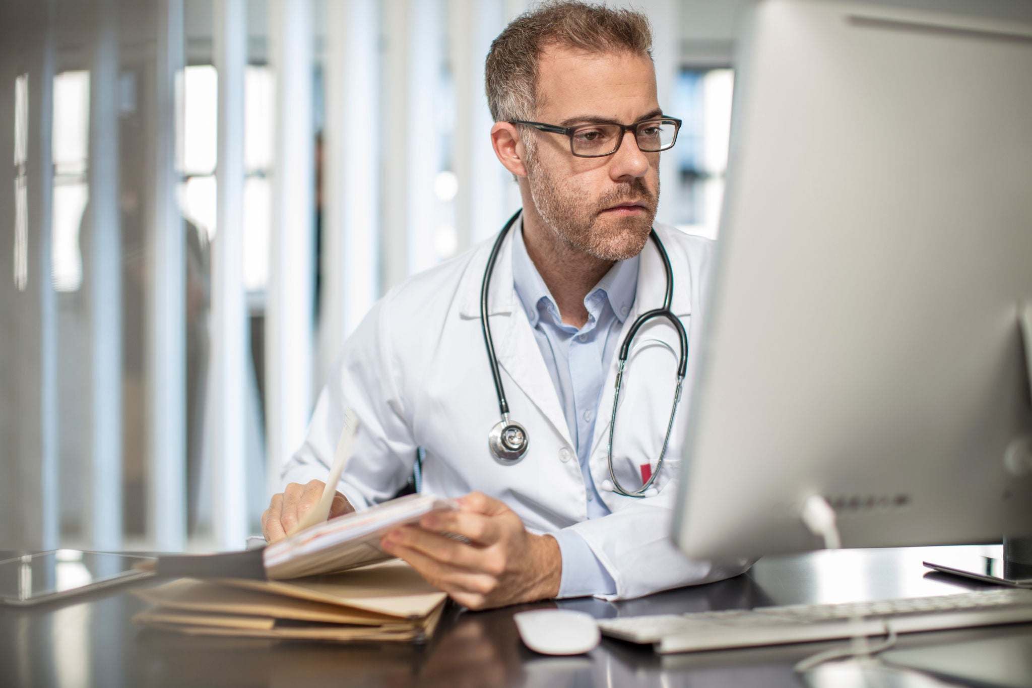 Physician looking at computer 