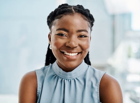 Woman in blue top smiling.